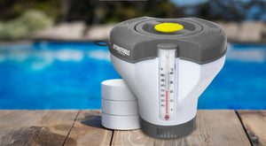 Pool chemical dispenser with HydroTools branding on a wooden deck by a pool.