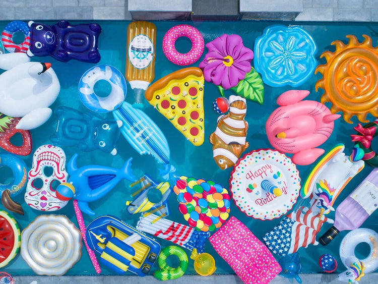 Assorted inflatable pool toys on a blue surface
